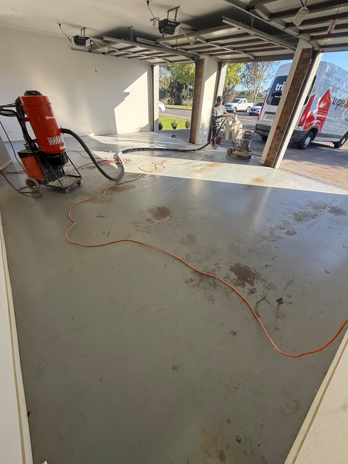Triple garage floor — bare concrete before